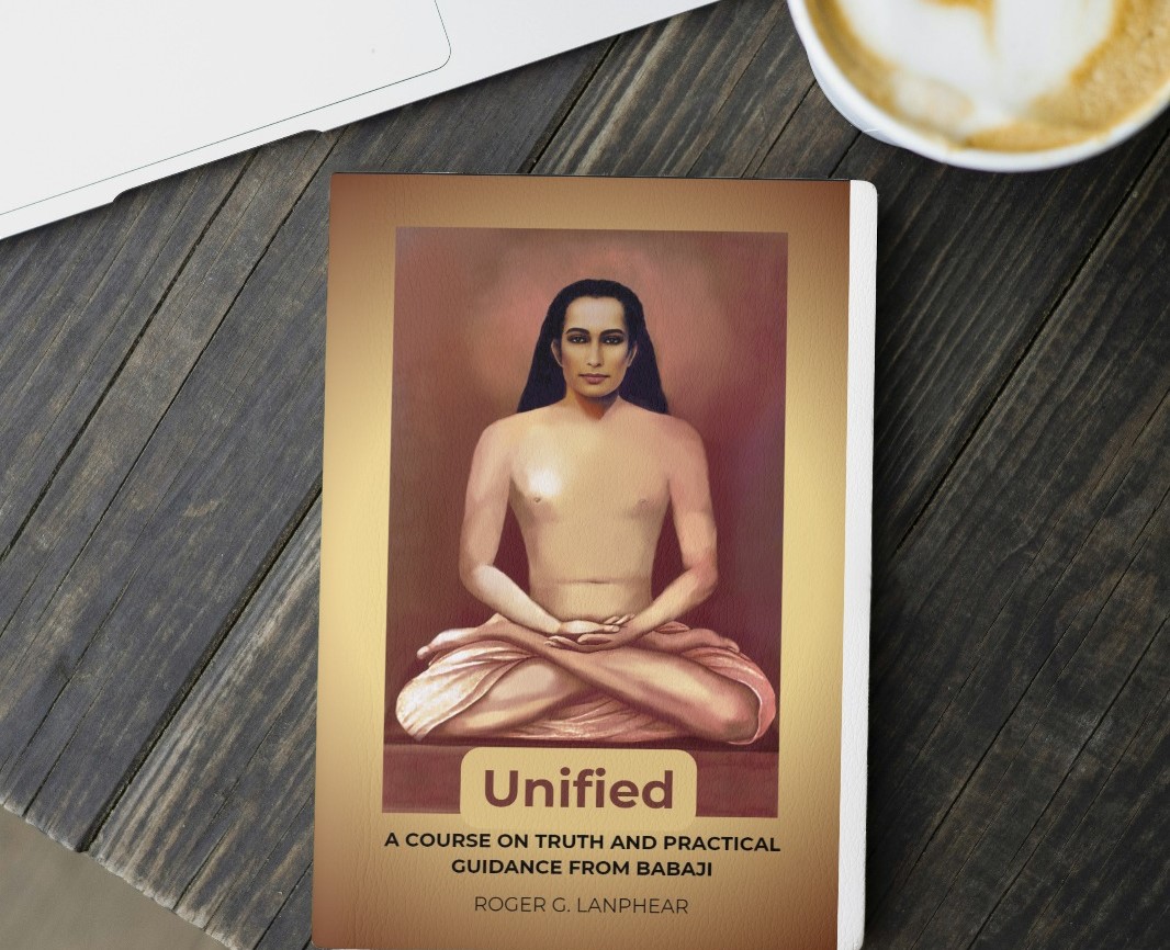 The cover of the book 'Unified: A Course on Truth and Practical Guidance from Babaji' by Roger G. Lanphear, resting on a wooden table next to a cup of coffee.